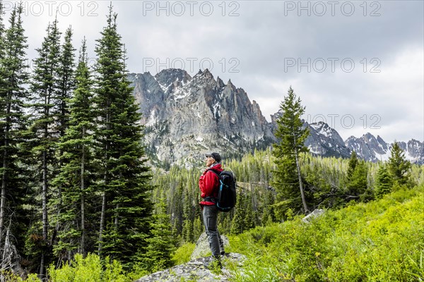 Senior man hiking by mountain in Stanley