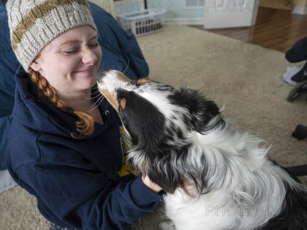 Girl petting Australian shepherd dog