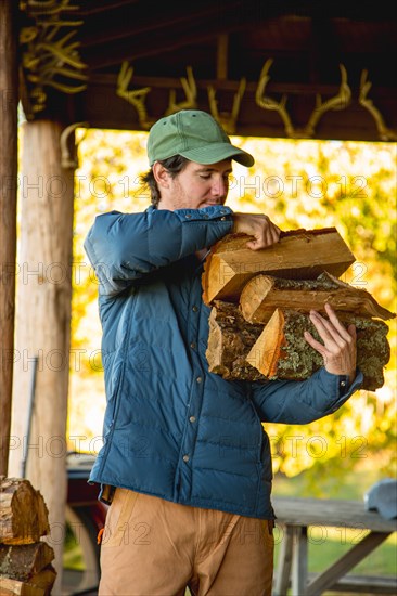 Young man holding firewood