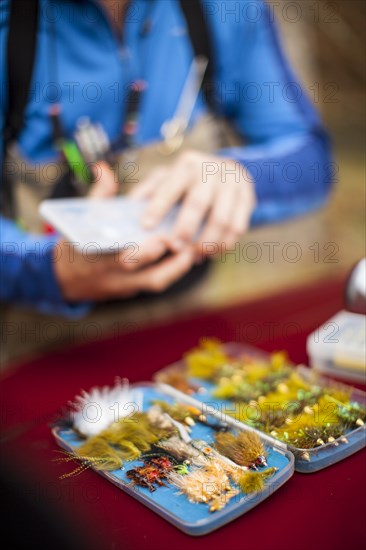 Man by box of tackle and lures