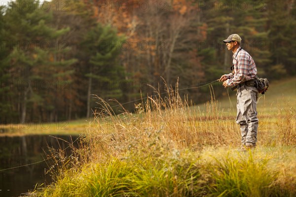 Man fly-fishing in river during autumn in Giles County