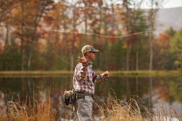 Man fly-fishing in river during autumn in Giles County