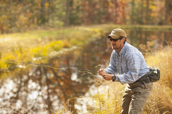 Man fly-fishing in river during autumn in Giles County