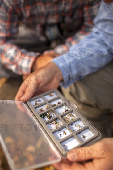 Men with box of dead insects to use as fishing lures