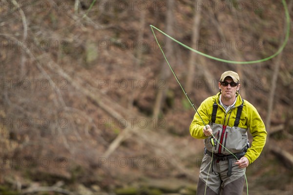 Young man fly-fishing