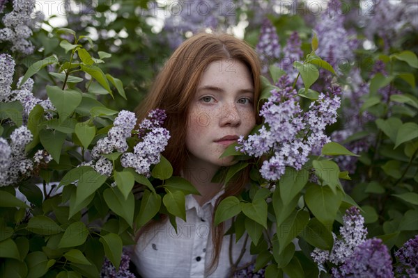 Teenage girl among purple flowers