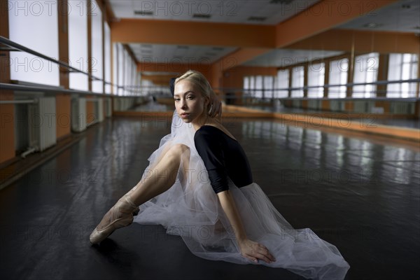 Ballet dancer sitting in studio