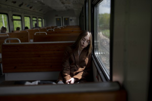 Young woman sleeping on train