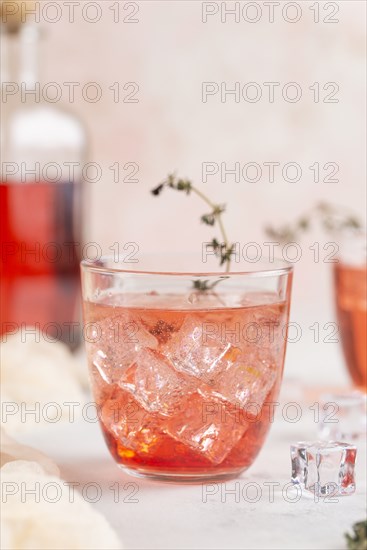 Pink cocktail with ice cubes