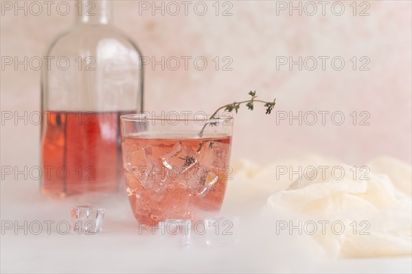 Pink cocktail with ice cubes