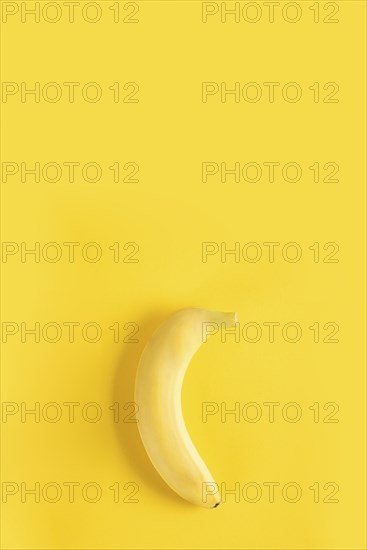 Banana on yellow surface