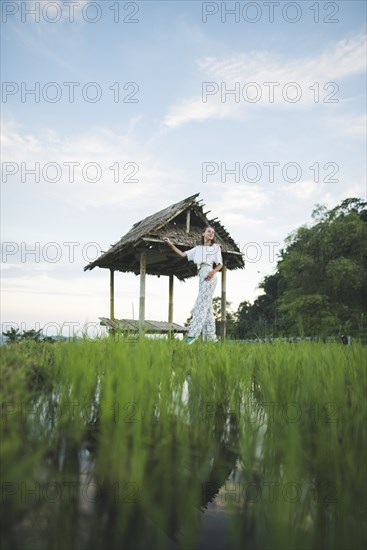 Woman walking in rice paddy in Bali