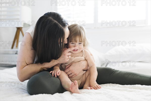 Woman touching her daughter's nose