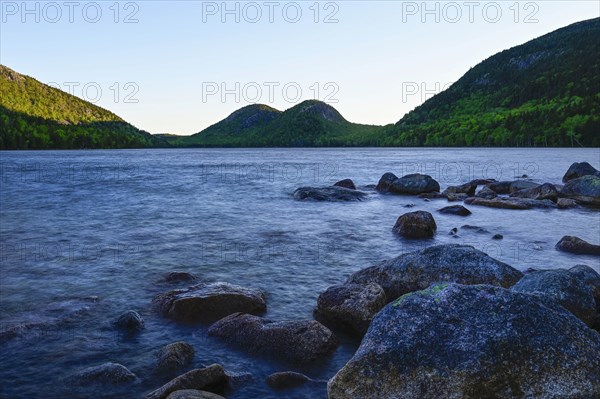 Rocks in Jordan Pond by hills in Acadia National Park, Maine, USA