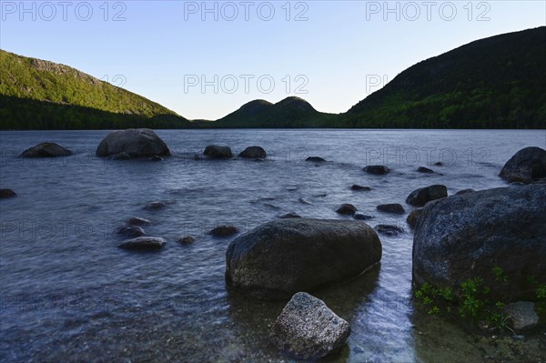 Rocks in Jordan Pond by hills in Acadia National Park, Maine, USA