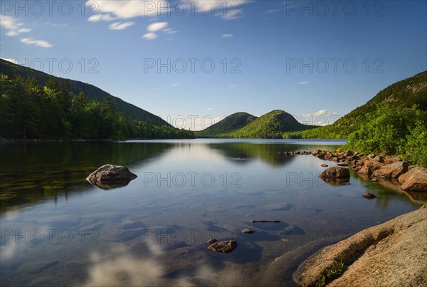 Rocks in Jordan Pond by hills in Acadia National Park, Maine, USA