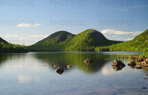 Rocks in Jordan Pond by hills in Acadia National Park, Maine, USA