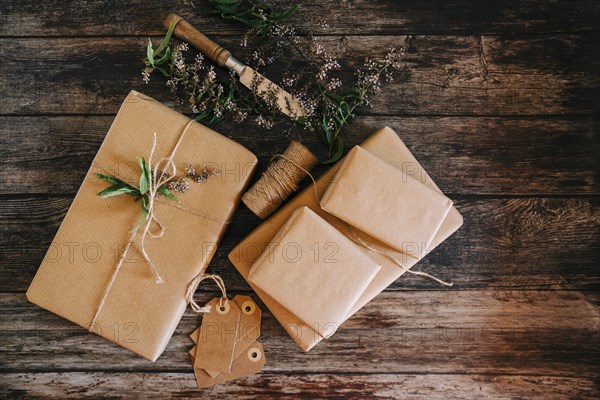 Presents wrapped in brown paper and string with labels and flowers