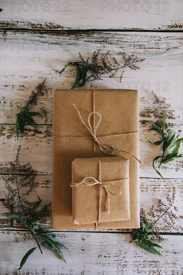 Presents wrapped in brown paper and string with flowers