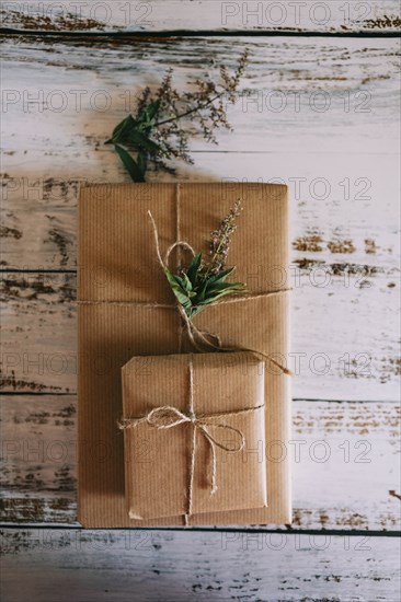 Presents wrapped in brown paper and string with flowers