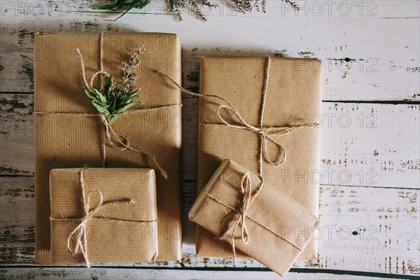 Presents wrapped in brown paper and string with flowers