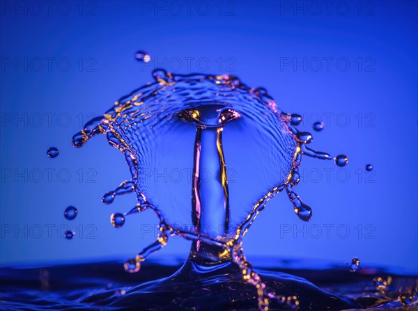 Splashing water against blue background