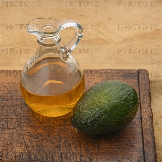 Avocado with pitcher of oil