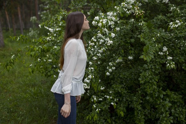 Young woman smelling flowers