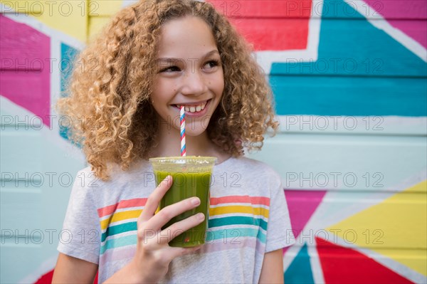 Girl drinking green juice