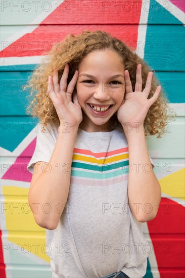 Girl in front of colorful wall