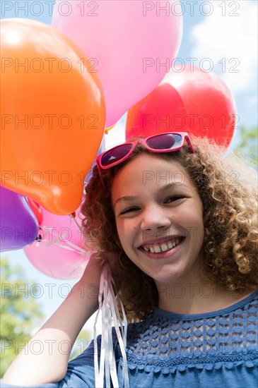 Girl holding balloons