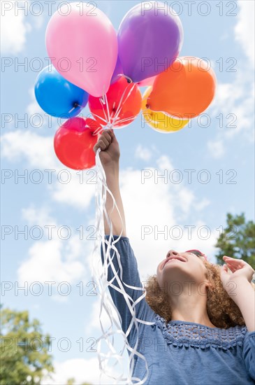 Girl holding balloons