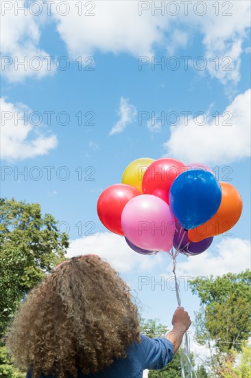 Girl holding balloons