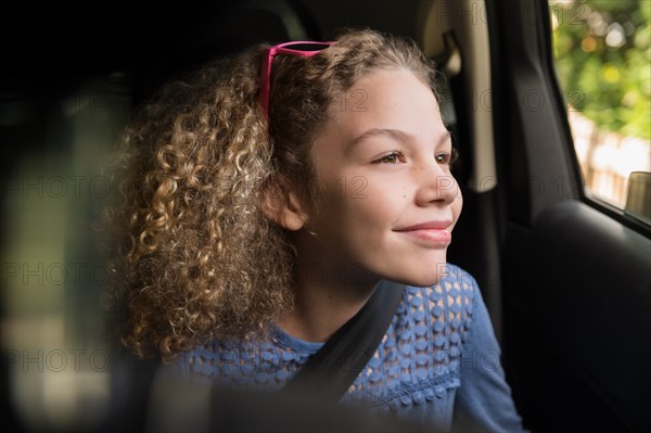 Girl wearing seatbelt in car