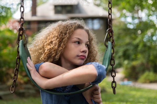 Girl leaning on swing