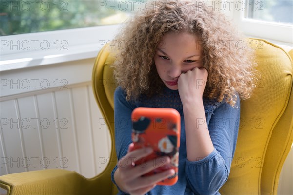 Bored girl using smartphone