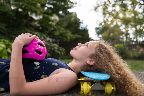 Girl lying on skateboard