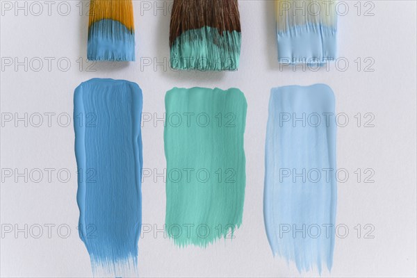 Paintbrushes and blue brushstrokes