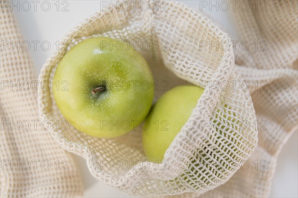 Green apples in reusable bag