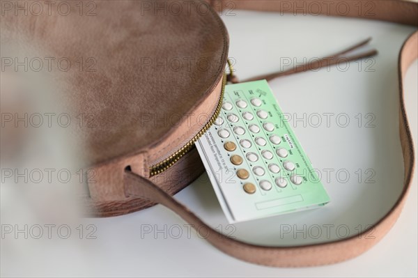 Birth control next to purse