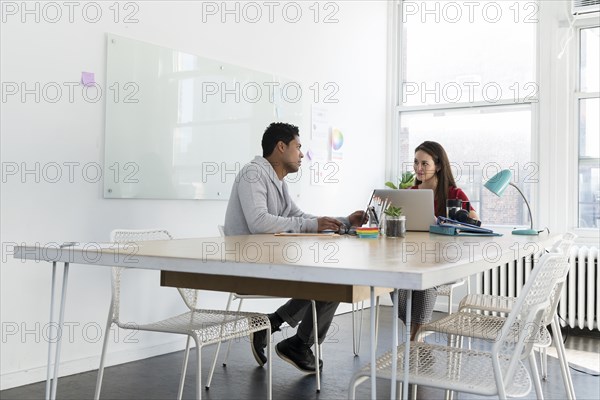 Coworkers sitting at office desk