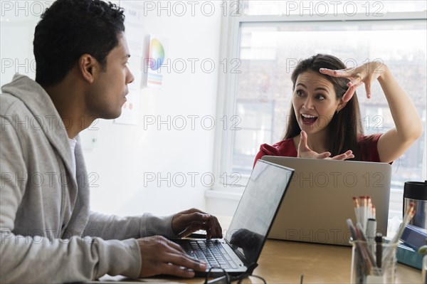 Businesswoman explaining something to coworker