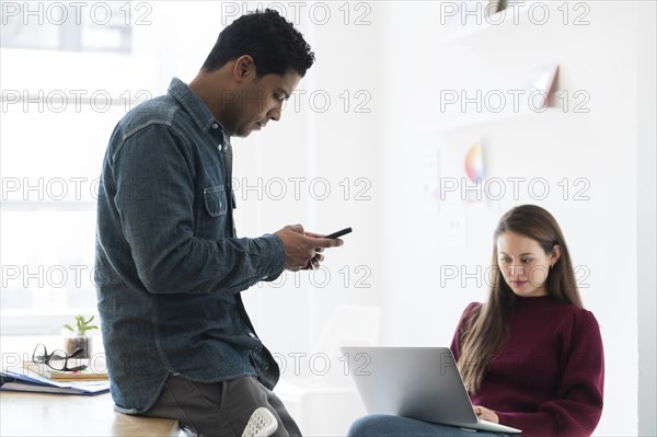 Colleagues working together in office