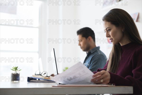 Coworkers working at office desk