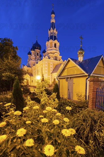 Flowers by St. Nicholas Church at night in Brest, Belarus