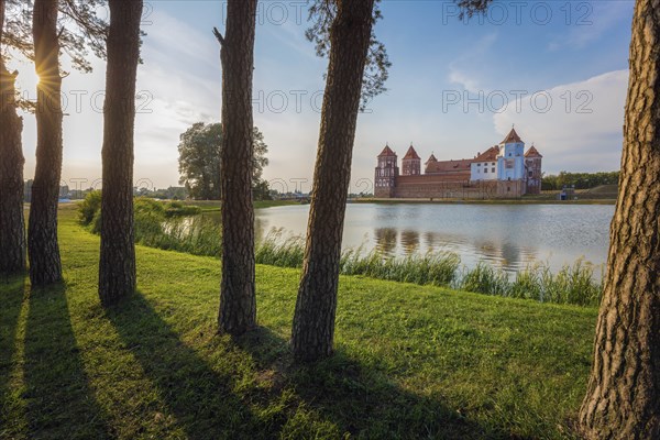 Lake by Mir Castle at sunset in Mir, Belarus