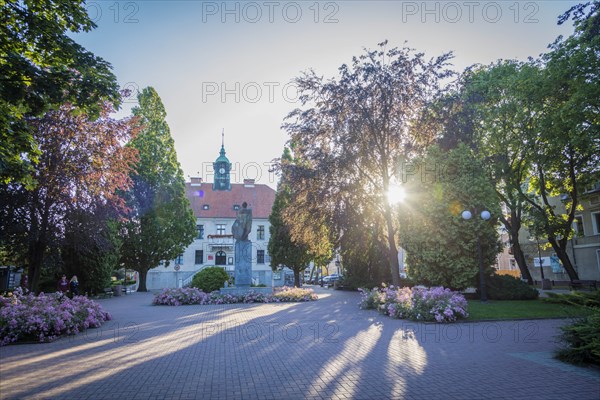 Town hall behind trees in Mragowo, Warmian-Masurian, Poland