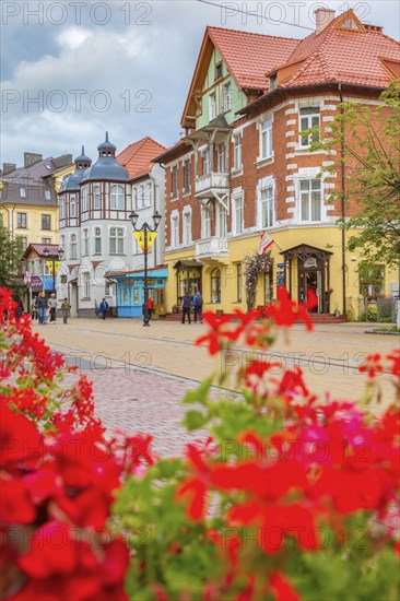 Flowers by old buildings in Zelenogradsk, Russia