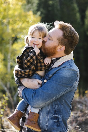 Father kissing his daughter's cheek