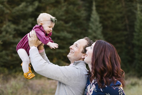 Parents and daughter by forest